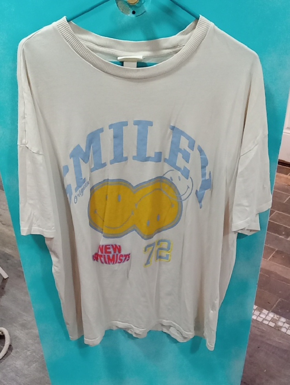(544) H&M Cream Short Sleeve Graphic Tee with Yellow & Blue Print